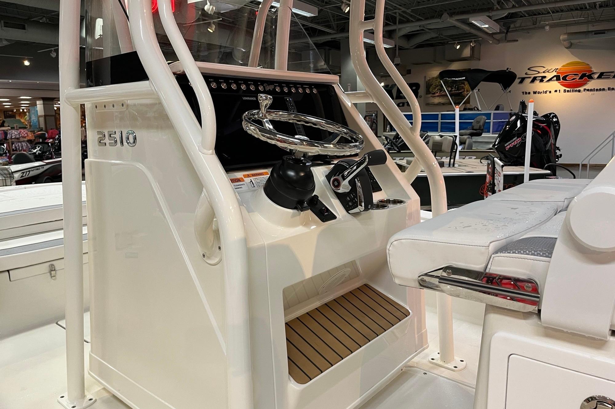 2026 Ranger 2510 Bay boat console with steering wheel and seating in showroom.