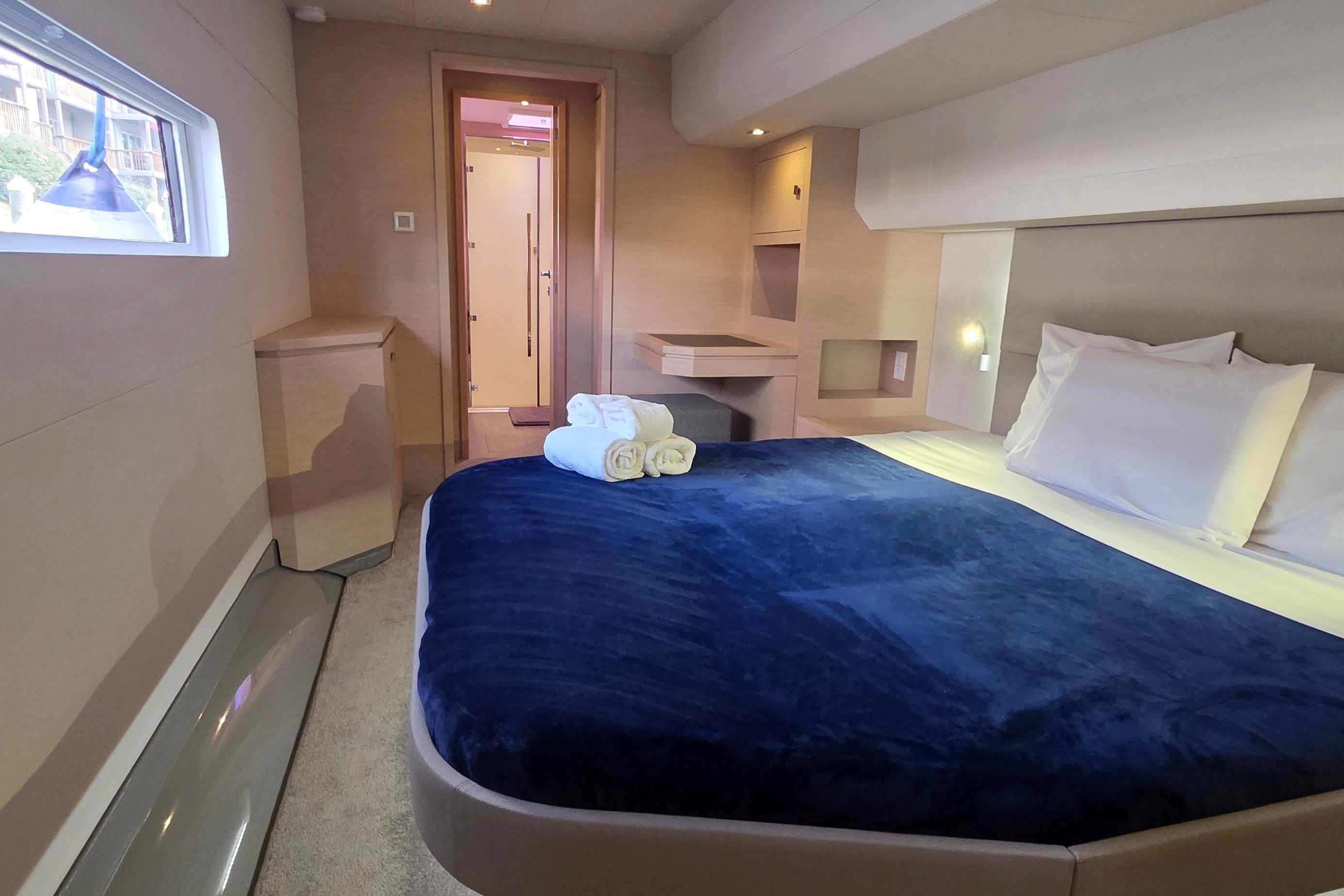 Luxurious cabin interior of 2018 Fountaine Pajot Motor Yacht 44 with cozy bedding.