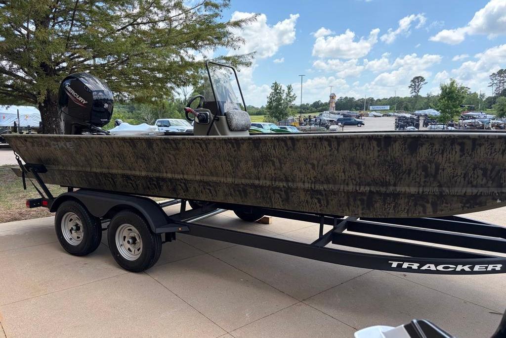 2026 Tracker Grizzly 2072 CC boat on trailer, parked outdoors under a clear sky.
