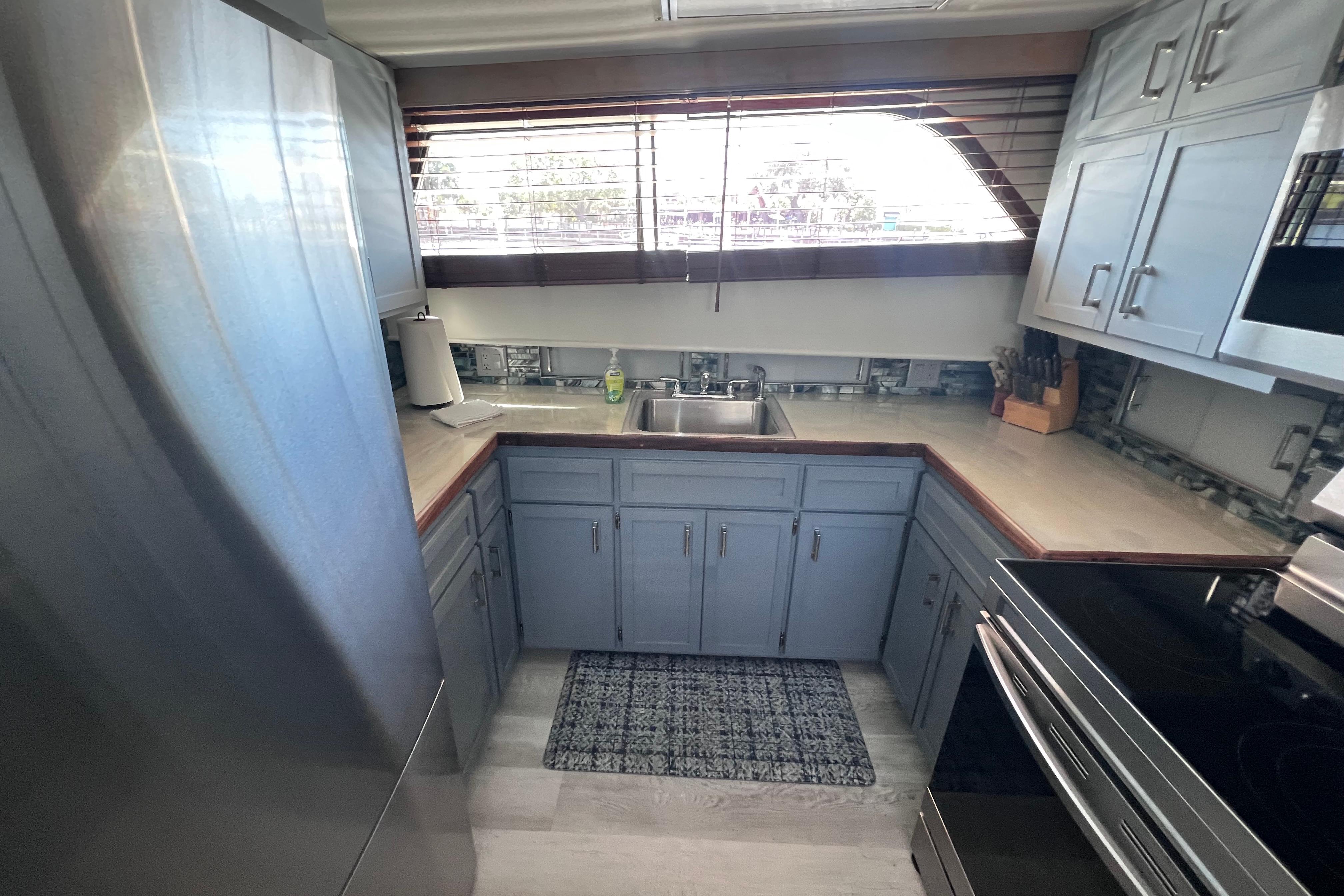 Kitchen interior of 1987 Hatteras 70 Cockpit Motor Yacht with modern appliances and cabinetry.