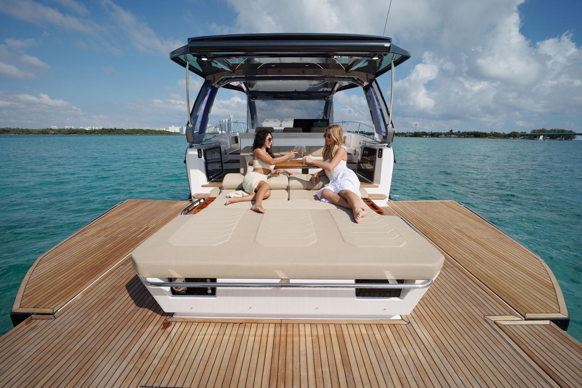 Two people relaxing on a Hanover 447 yacht, 2026 model, enjoying the ocean view.