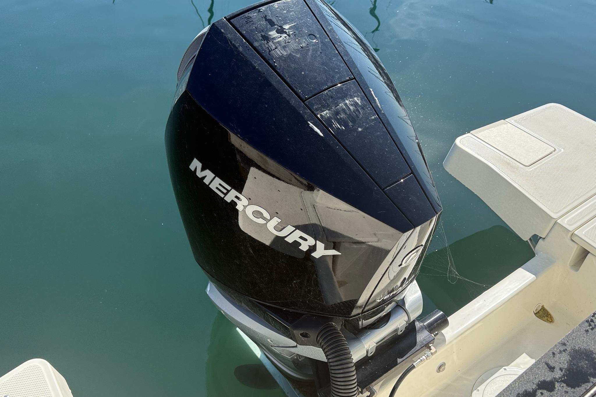 2024 Bayliner Trophy T25 Pilothouse with Mercury outboard engine on calm water.