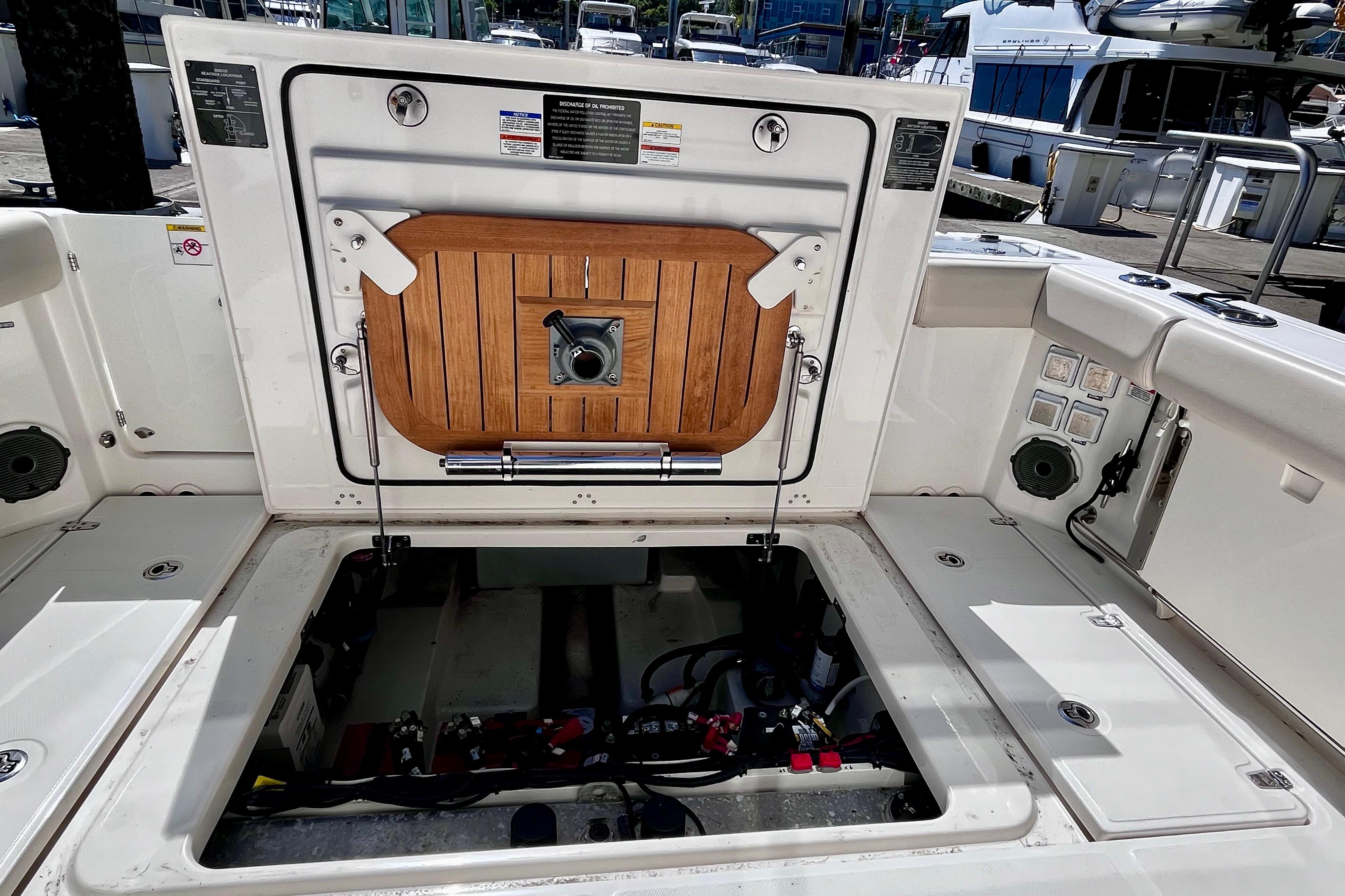 Boston Whaler 325 Conquest Pilothouse 2026 engine compartment with open hatch at marina.