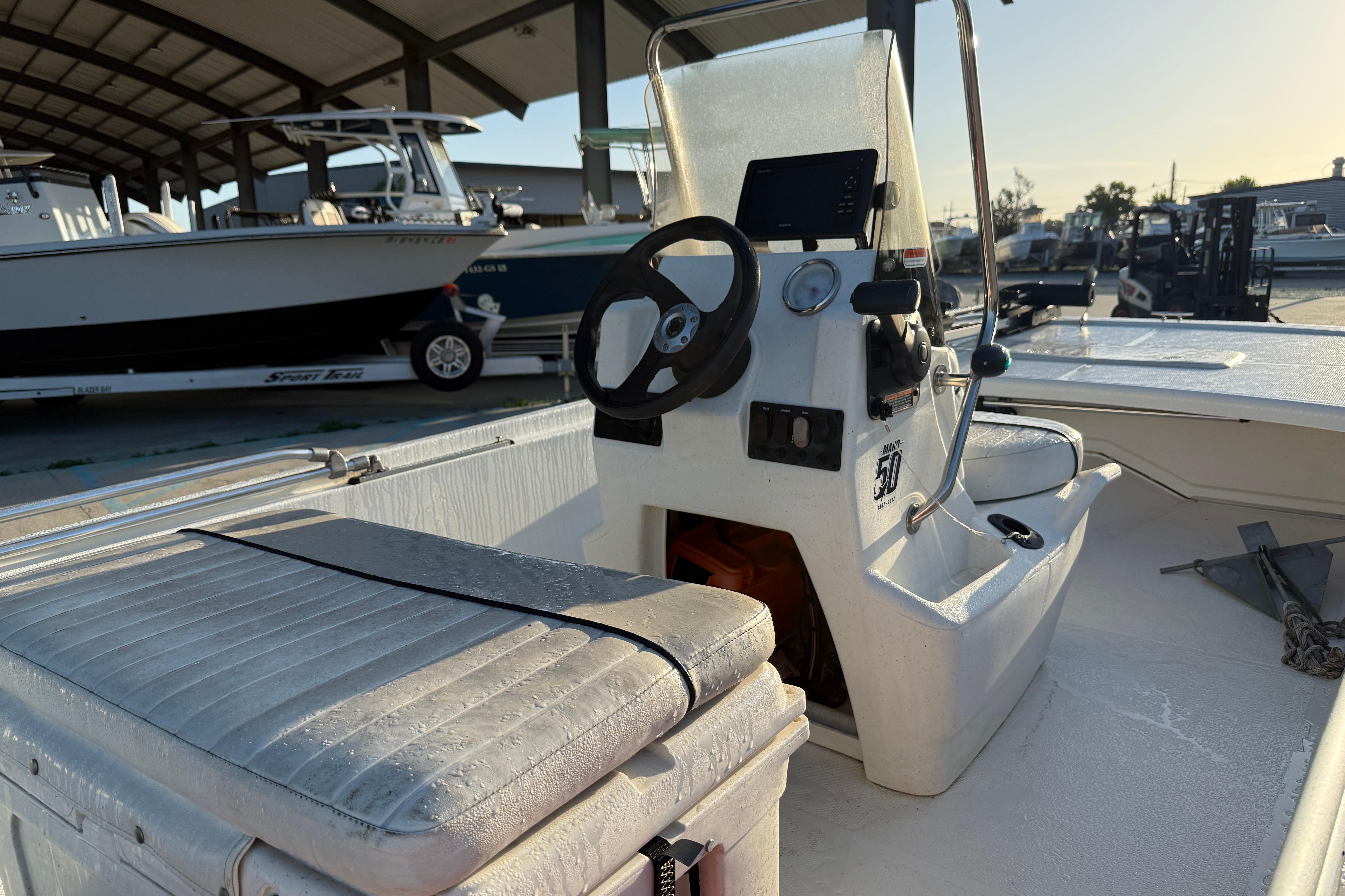 2017 Mako Pro Skiff 17 CC boat interior with steering console and seating.