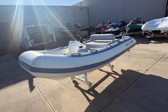 2018 Williams 345 Sports Jet boat on display in a sunny outdoor setting.