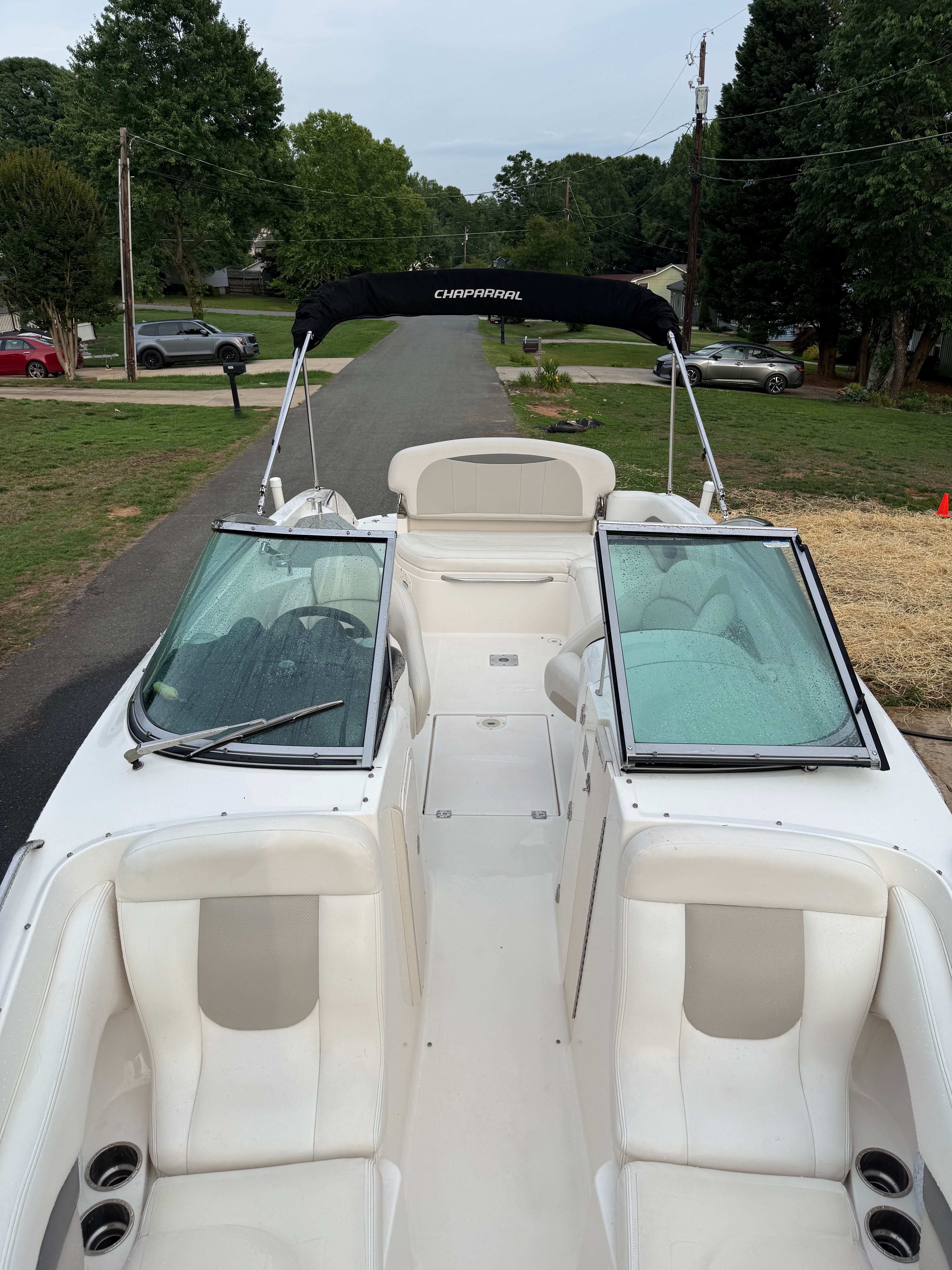 2007 Chaparral 256 SSX with open cockpit and Bimini top, parked on a trailer.