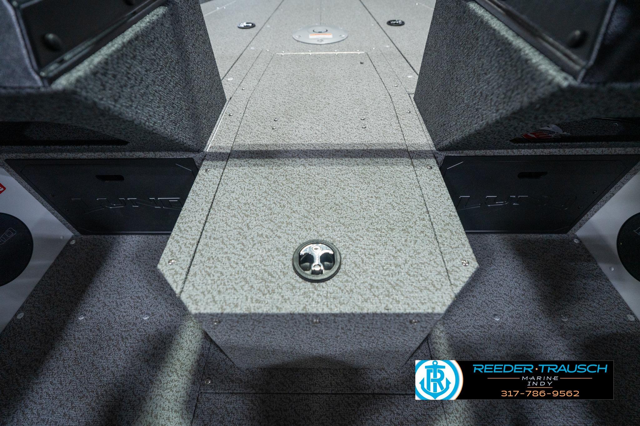 Interior view of 2026 Lund 1700 Explorer Sport boat, featuring carpeted flooring and storage compartments.