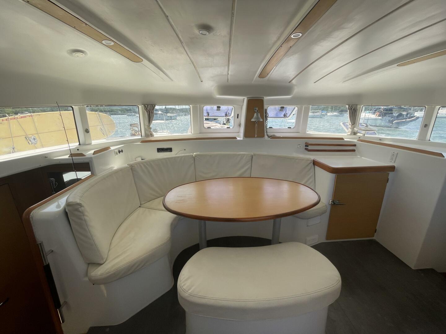 Interior of 2016 Lagoon 380 catamaran with round table and cushioned seating.