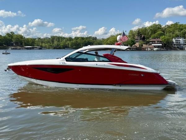 2022 Cobalt A36BR boat on a lake, red and white design, sunny day, American flag.