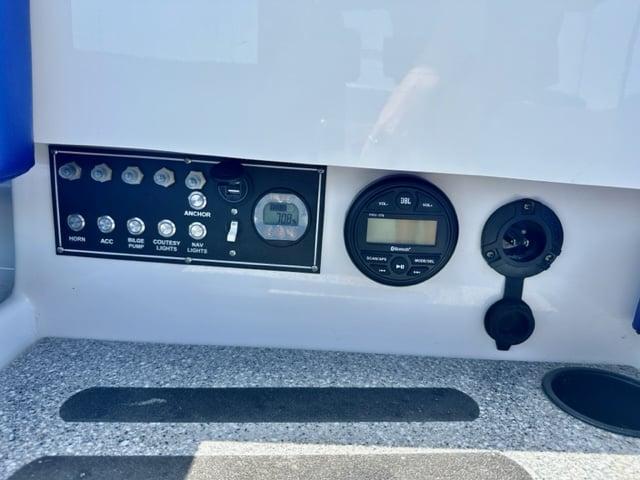Control panel of 2023 Vision Marine Technologies Fantail 217 boat with various switches and gauges.