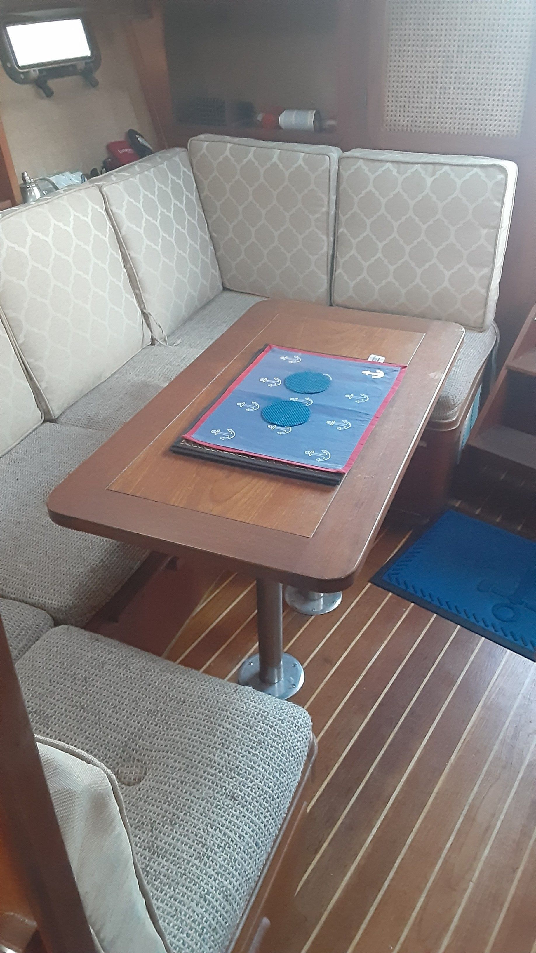 Interior of a 1985 Tiara Yachts 3100 Open with table and seating area.