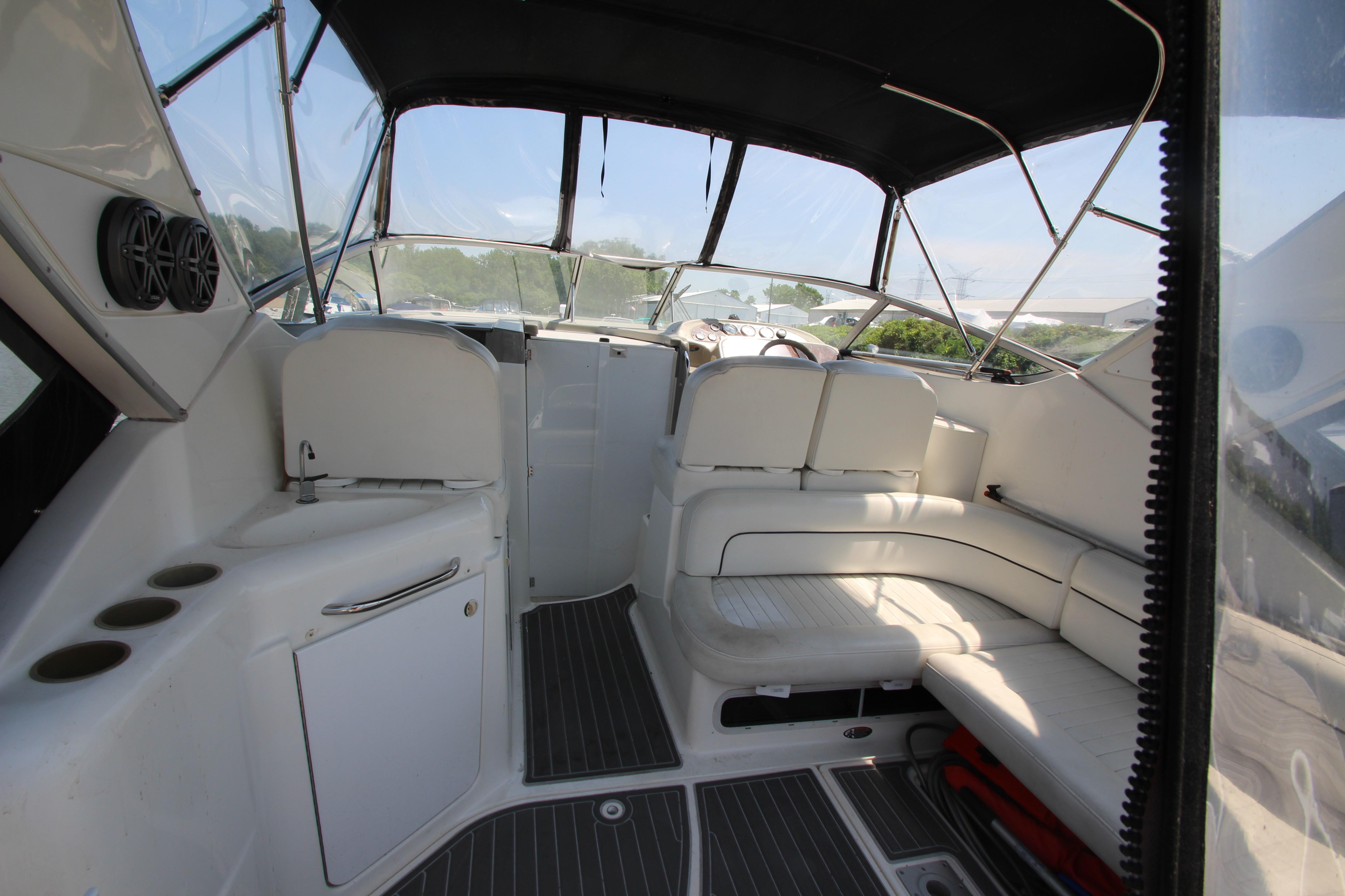 1999 Bayliner 3055 Ciera boat interior with white seating and modern amenities.
