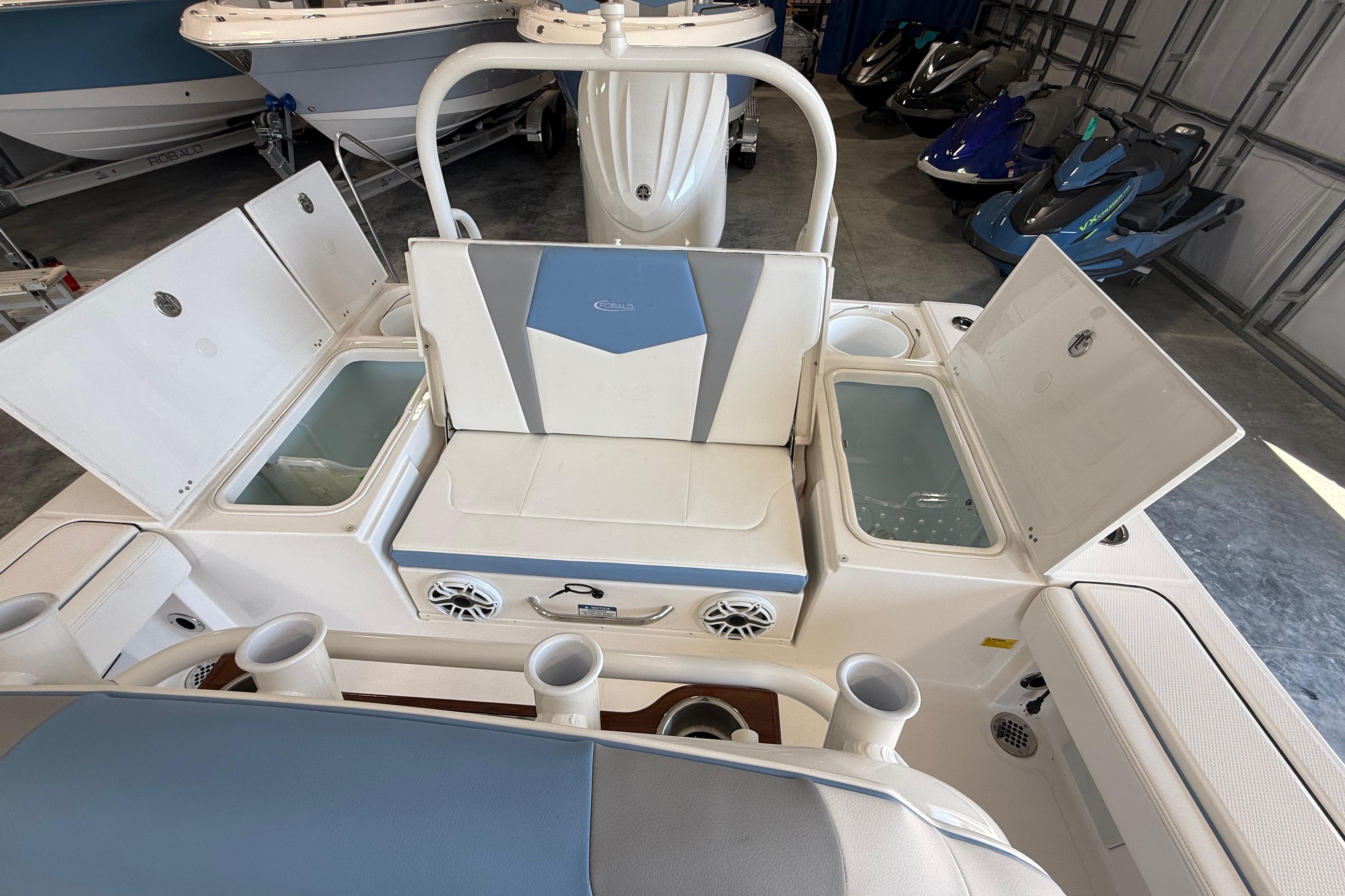 2026 Robalo 246 Cayman boat interior with open storage compartments and seating.