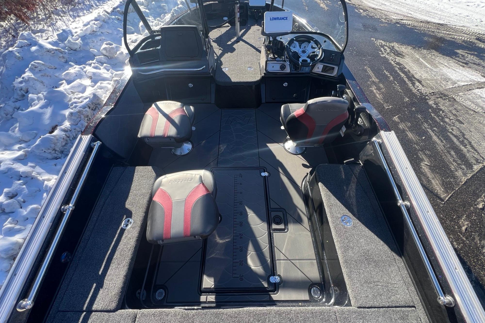 2026 Nitro ZV20 boat interior with red and black seats, snowy background.