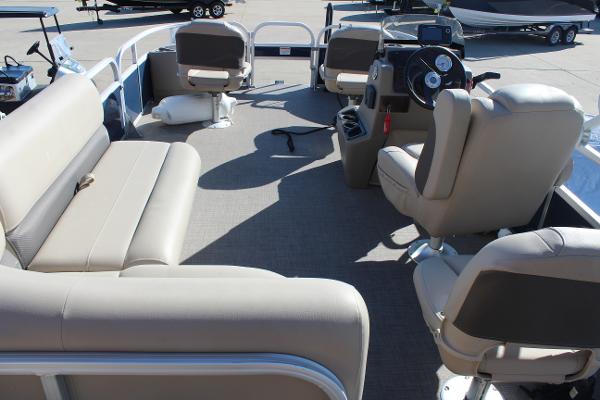 2024 Sun Tracker BB18 pontoon boat interior with beige seating and steering console.