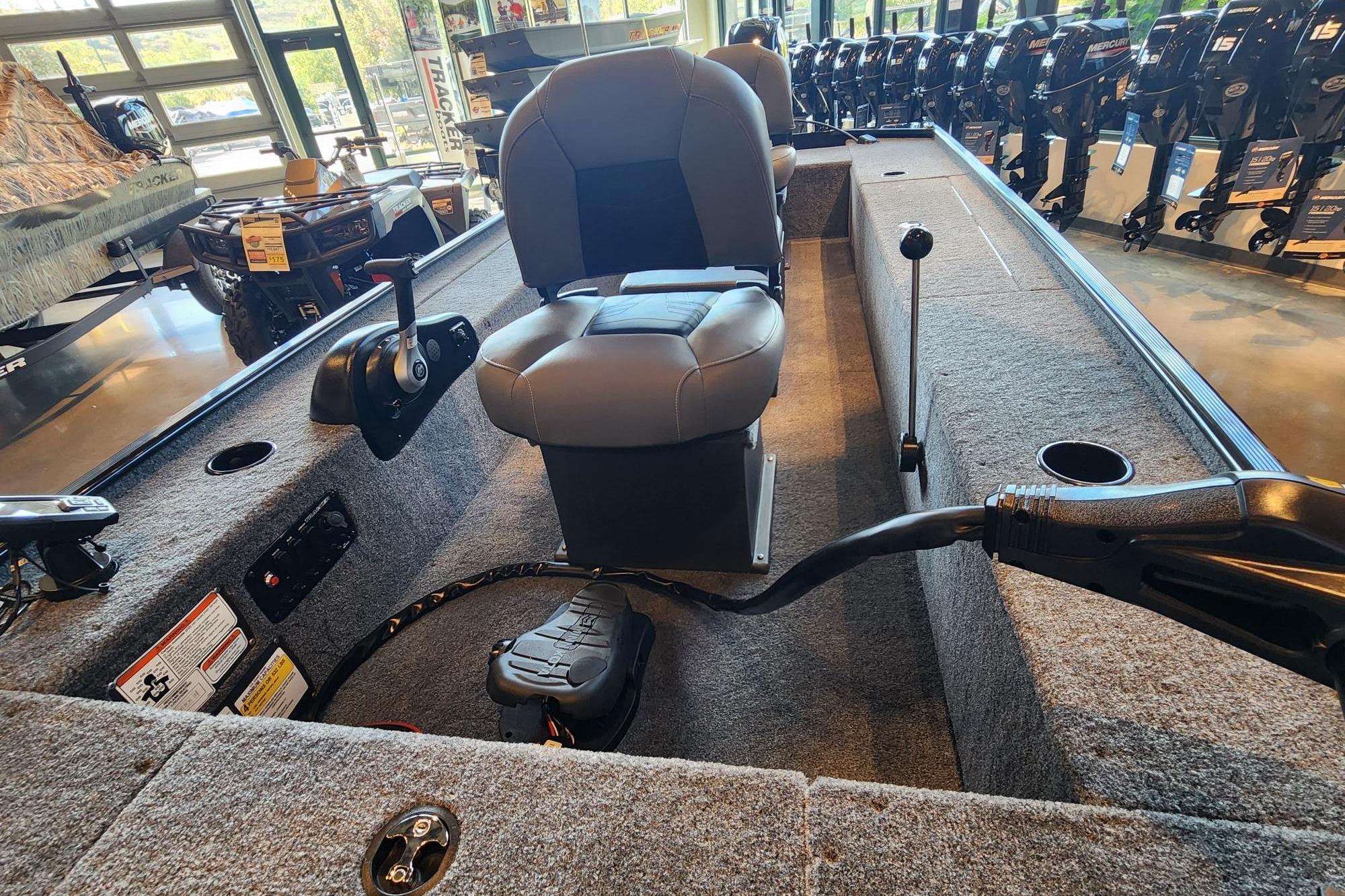 2026 Tracker Panfish 17 boat interior with seating and controls in showroom.