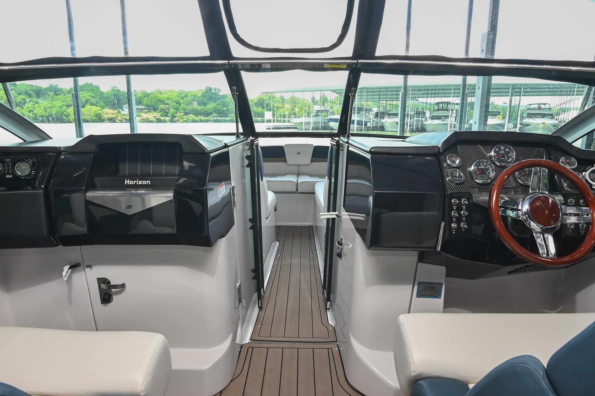 Interior of 2014 Four Winns H290 boat with sleek dashboard and modern controls.