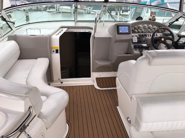 Interior of a 2004 Cruisers Yachts 3372 Express with white leather and wood accents.