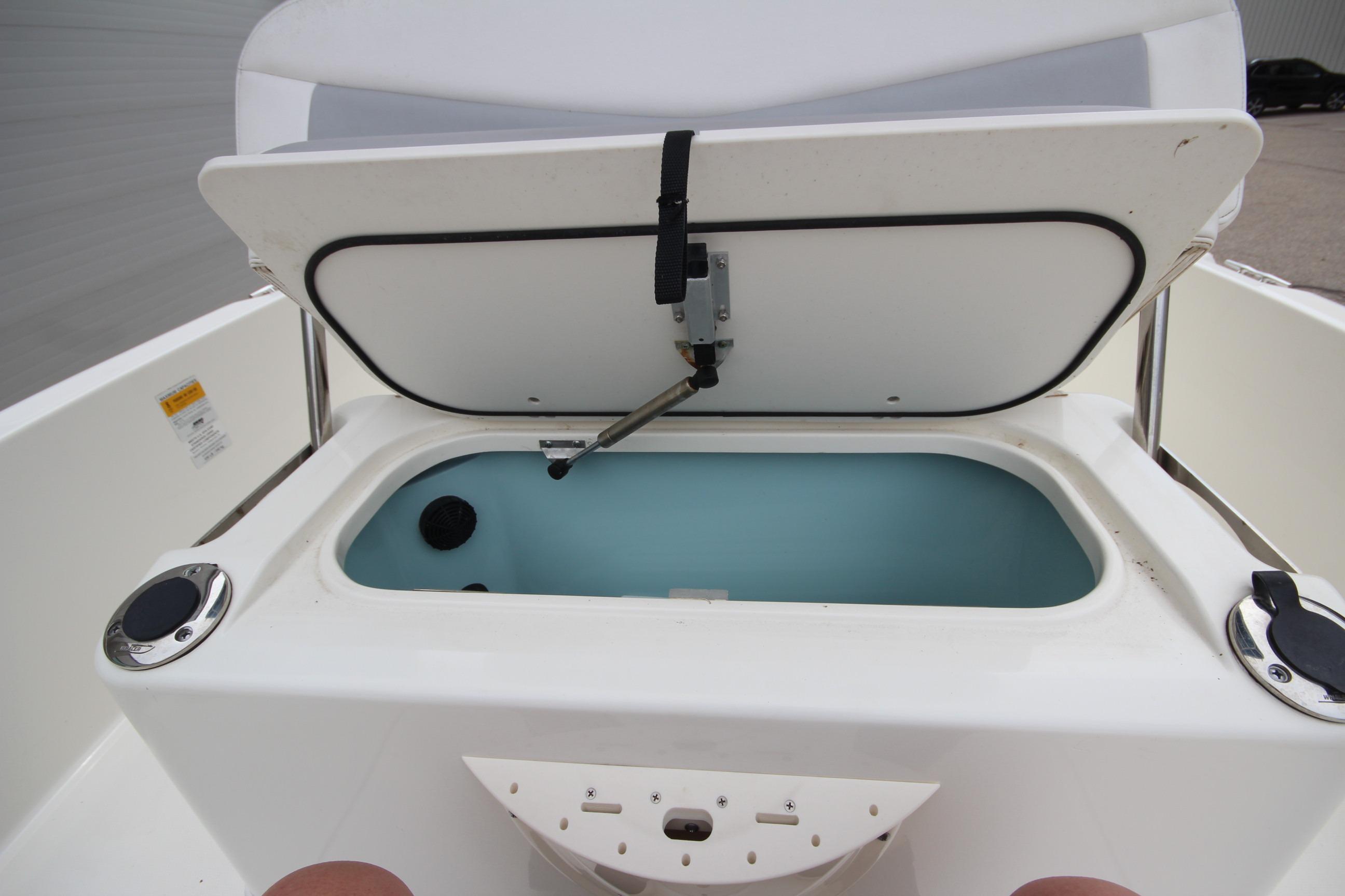 Open storage compartment on a 2014 Boston Whaler 210 Dauntless boat.