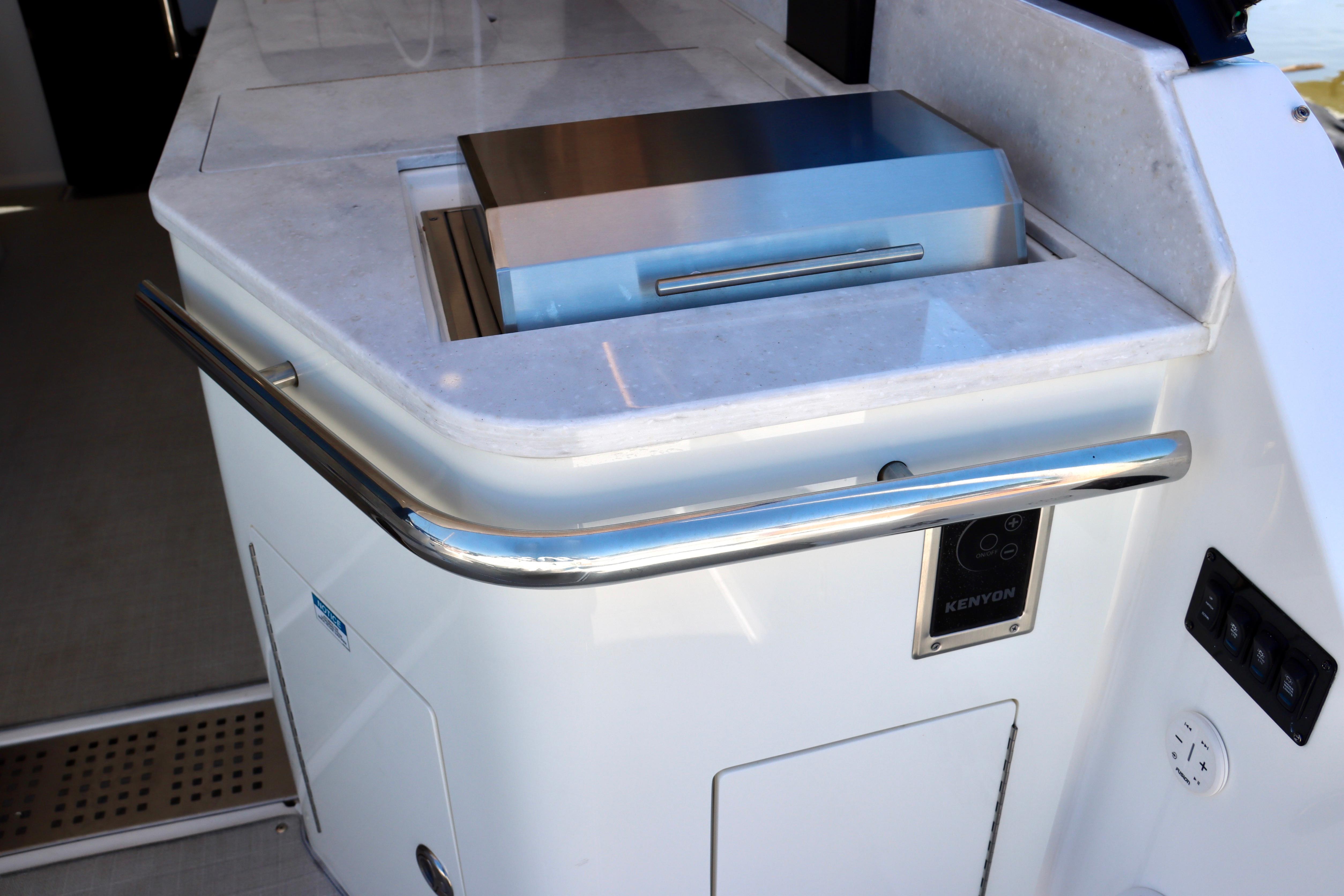 Outdoor kitchen area on 2022 Regal 36 Grande Coupe yacht with Kenyon grill.