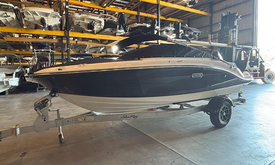 2025 Sea Ray SPX 190 Outboard boat on trailer in storage facility.