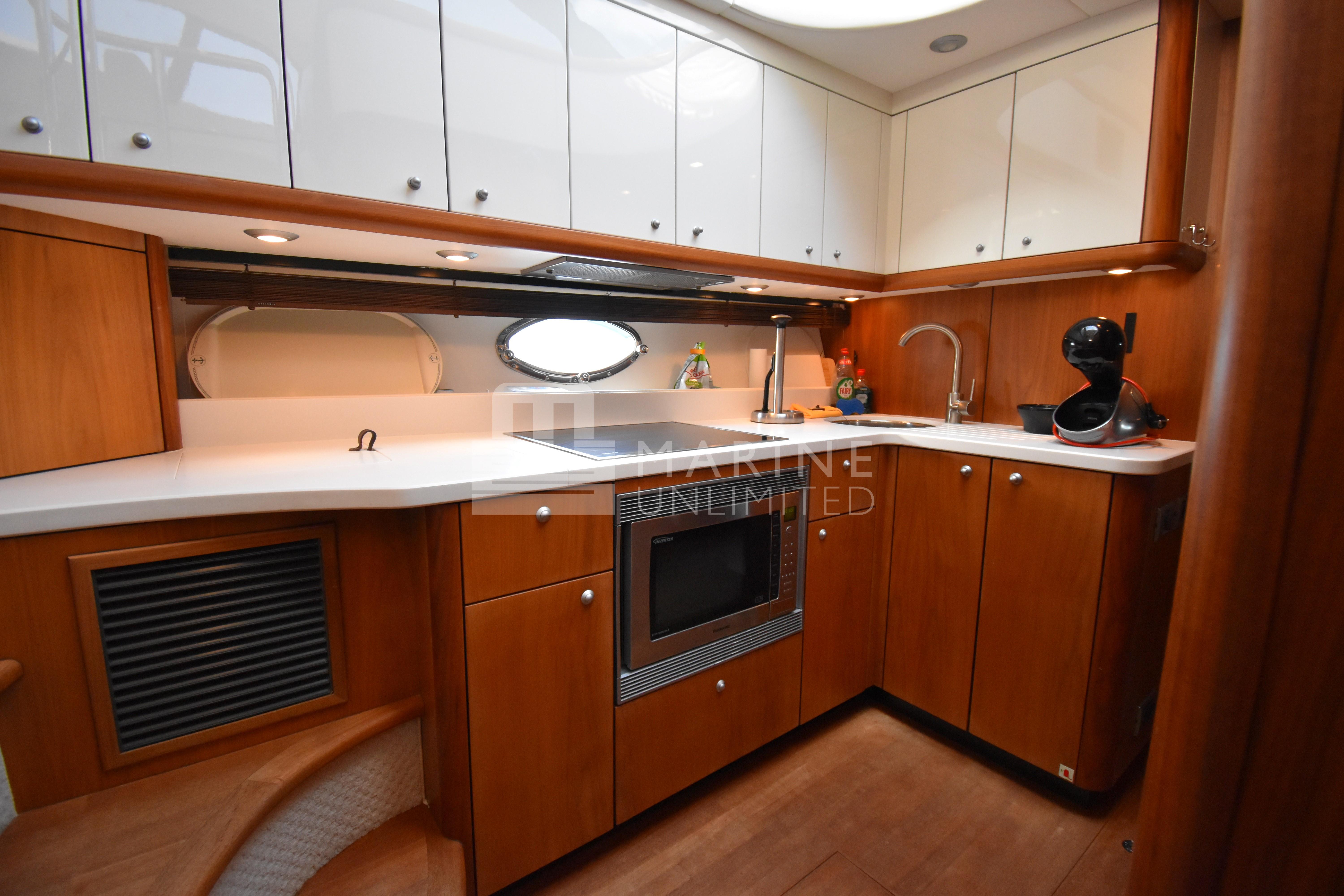 Luxurious kitchen interior of 2010 Sunseeker Manhattan 52 yacht with modern appliances.