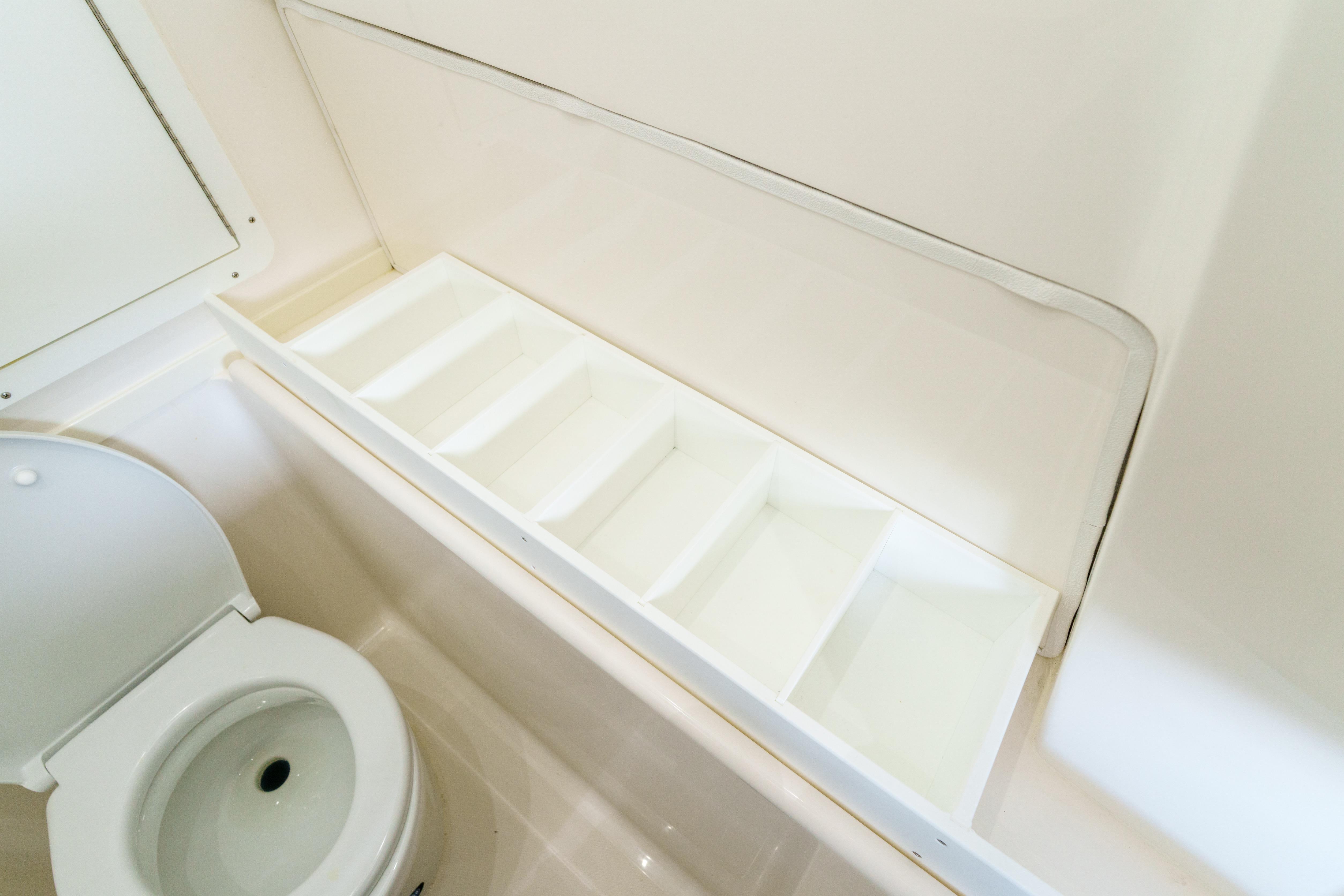 Interior of 2022 SeaVee 370Z boat bathroom with toilet and storage compartments.