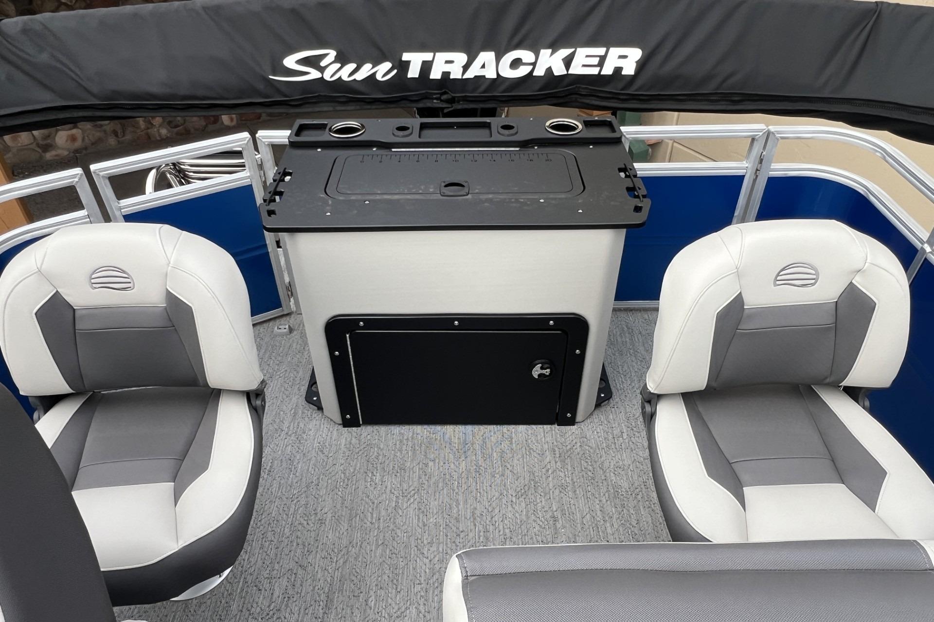 2026 Sun Tracker Fishin' Barge 20 DLX interior with seating and storage.