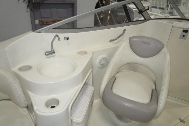 2004 Stingray 240 LR boat interior with sink and cushioned seat.