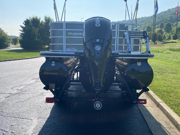 2024 Ranger Reata 223C pontoon boat with outboard motor, parked on a sunny day.