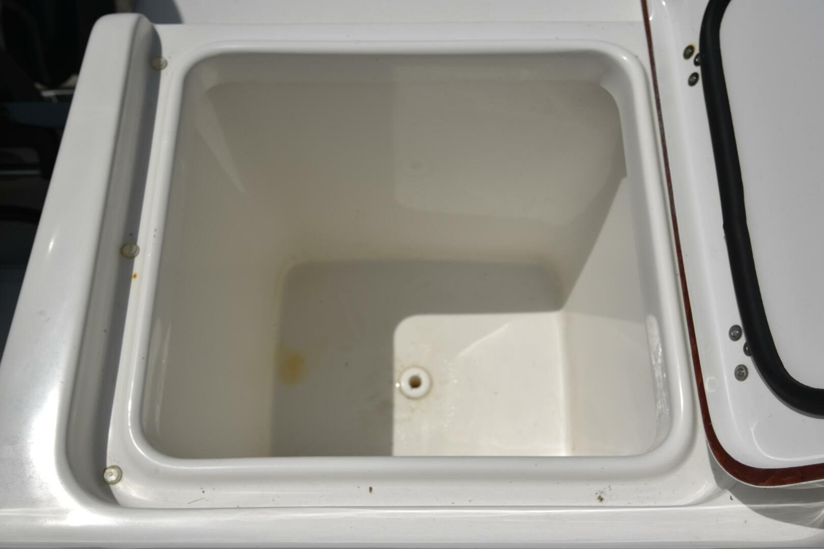 Open storage compartment on 2023 Sea Pro 239 Deep V CC boat.