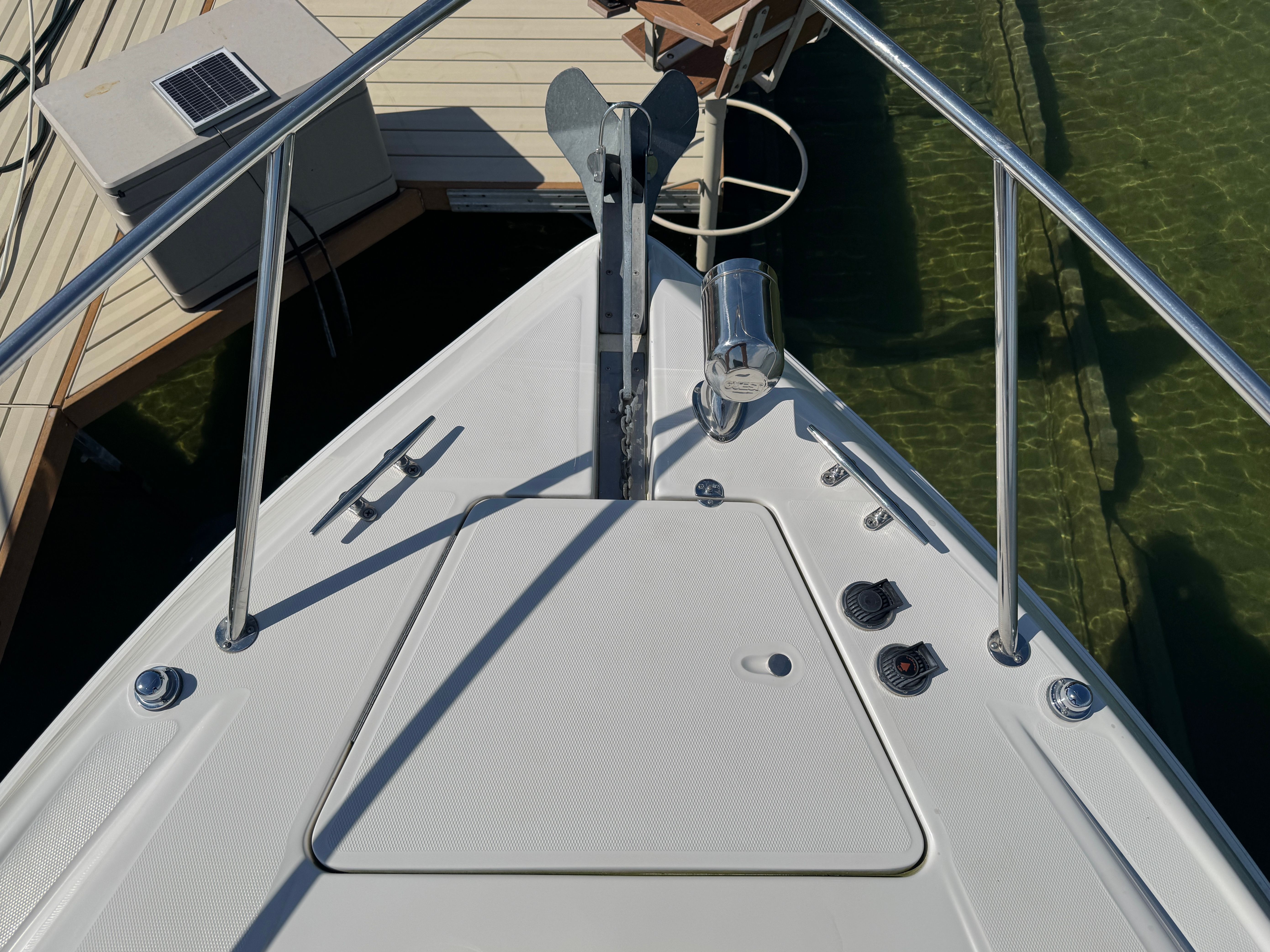 Bow of a 2004 Regal Commodore 3260 boat at dock.