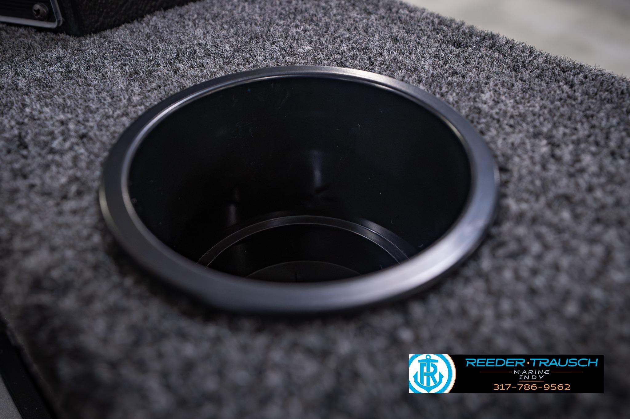 Cup holder on 2026 Lund 1650 Rebel XL SS boat with carpeted surface.