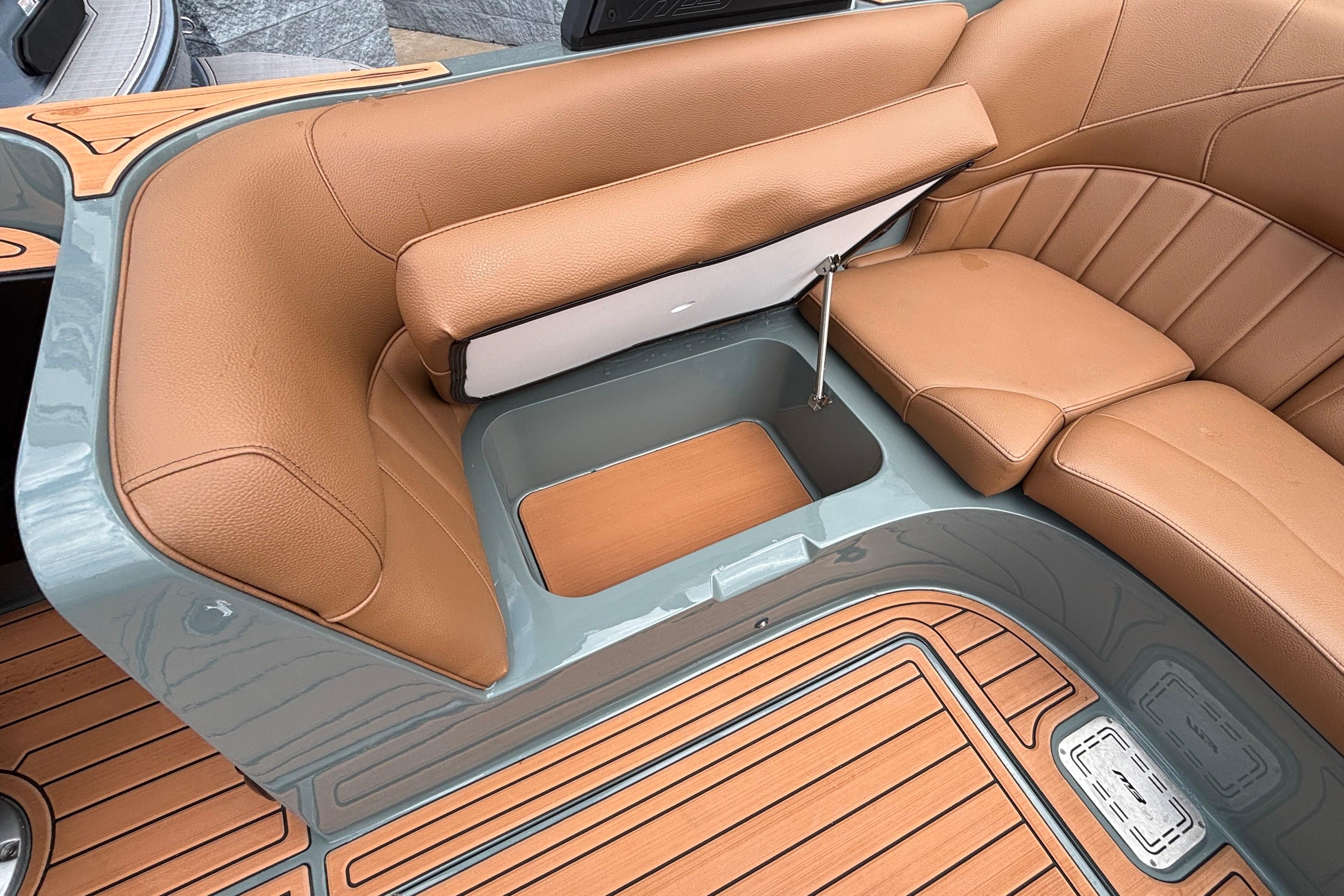 Luxurious seating area of 2026 MB B52 23 Classic boat with storage compartment.