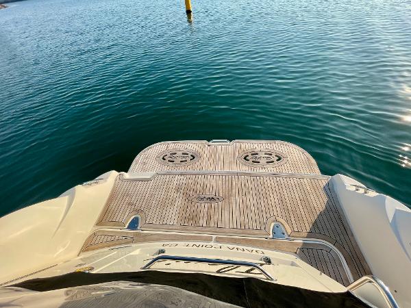 2014 Sea Ray 330 Sundancer boat stern with teak deck on calm water.