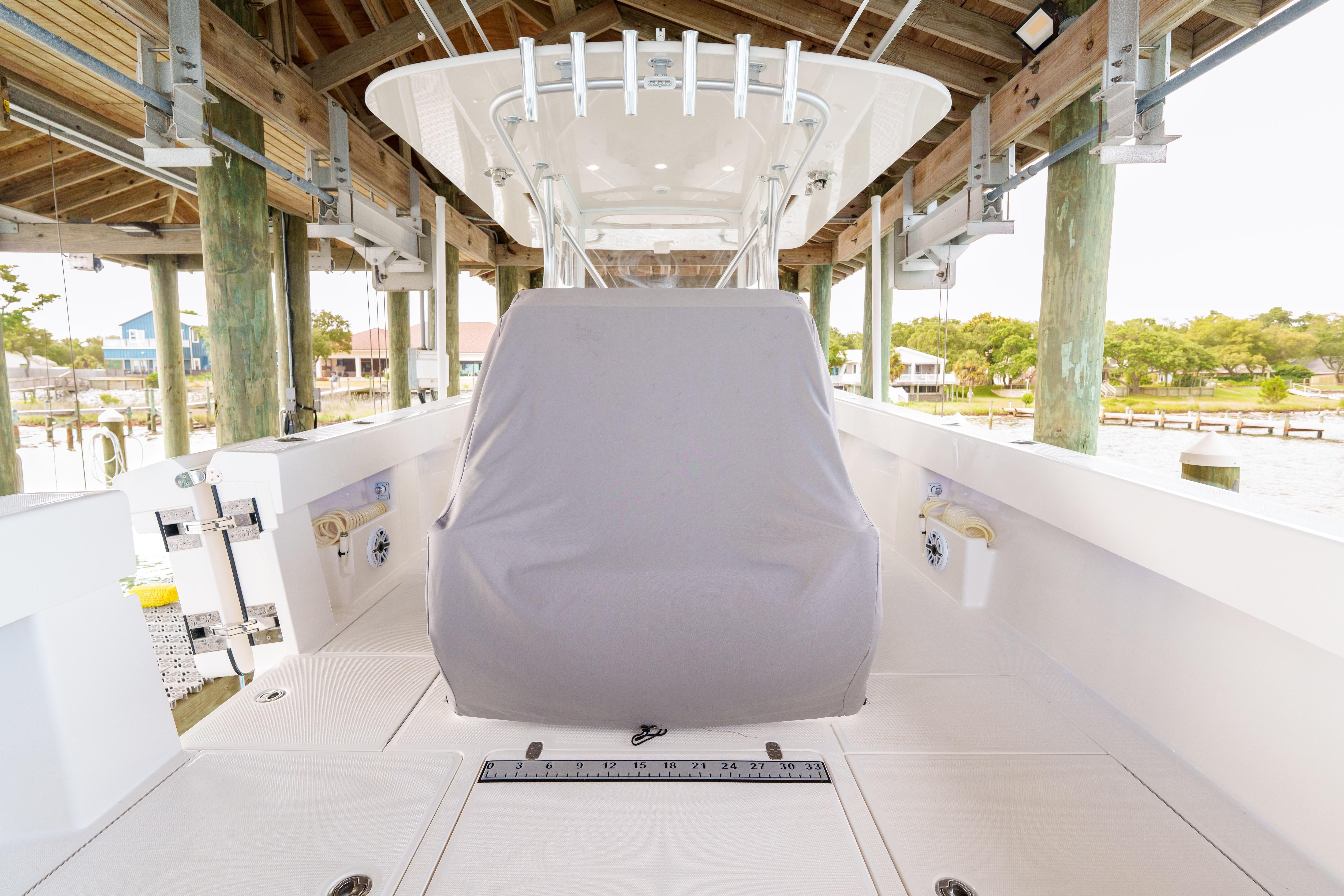 2022 SeaVee 370Z boat under dock, featuring covered console and spacious deck.