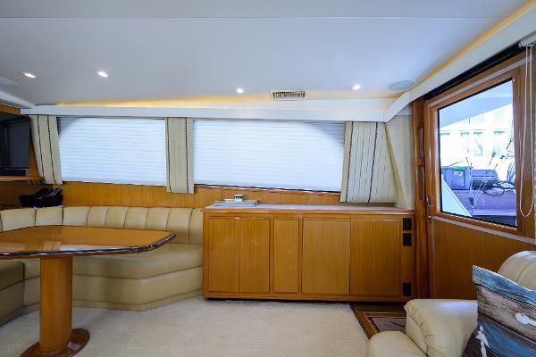 Interior of 2000 Viking 50 Convertible yacht with elegant wood finishes and plush seating.