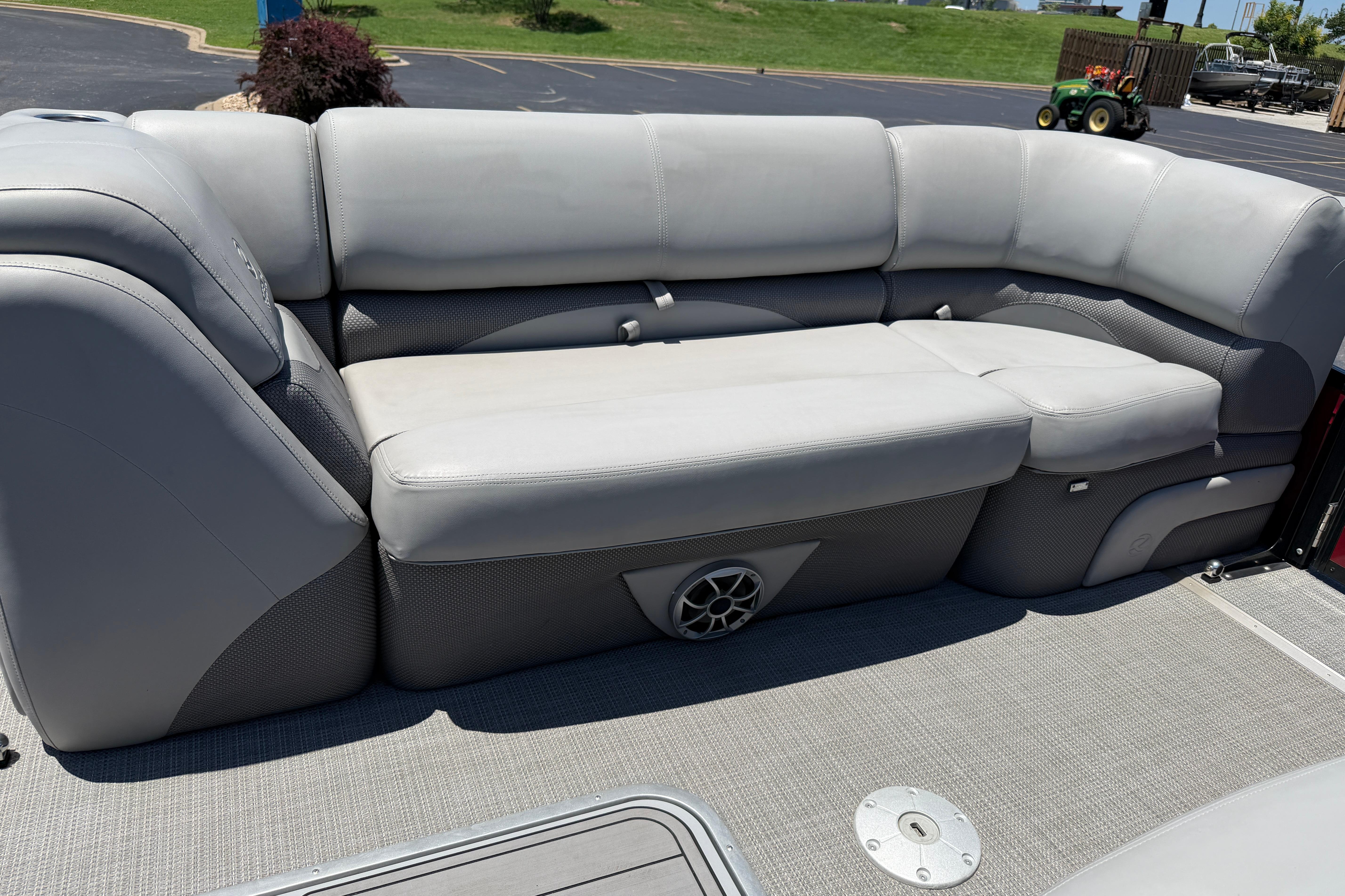 2024 Regency R250DL3 boat interior with gray cushioned seating and speaker system.
