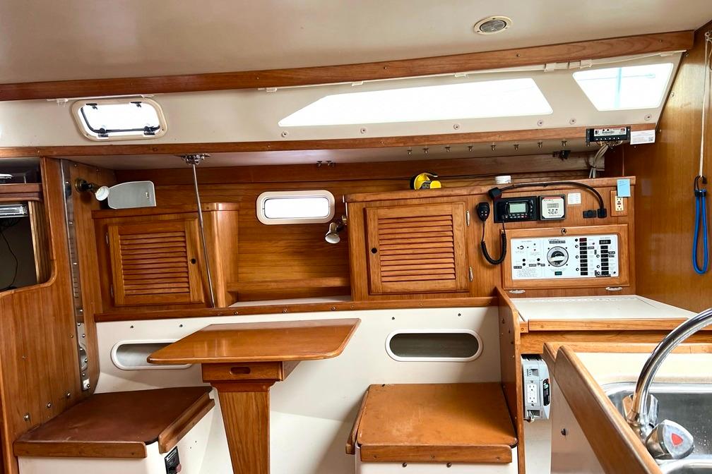 Interior of 1998 Catalina 36 MkII sailboat with wooden cabinetry and navigation equipment.