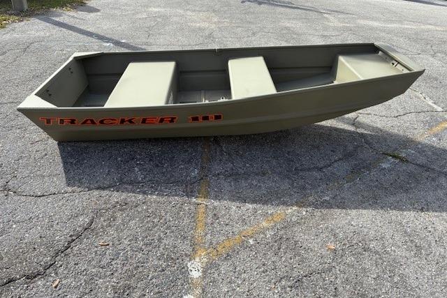 2025 Tracker Grizzly 1036 Utility boat on pavement, showcasing its sturdy design.