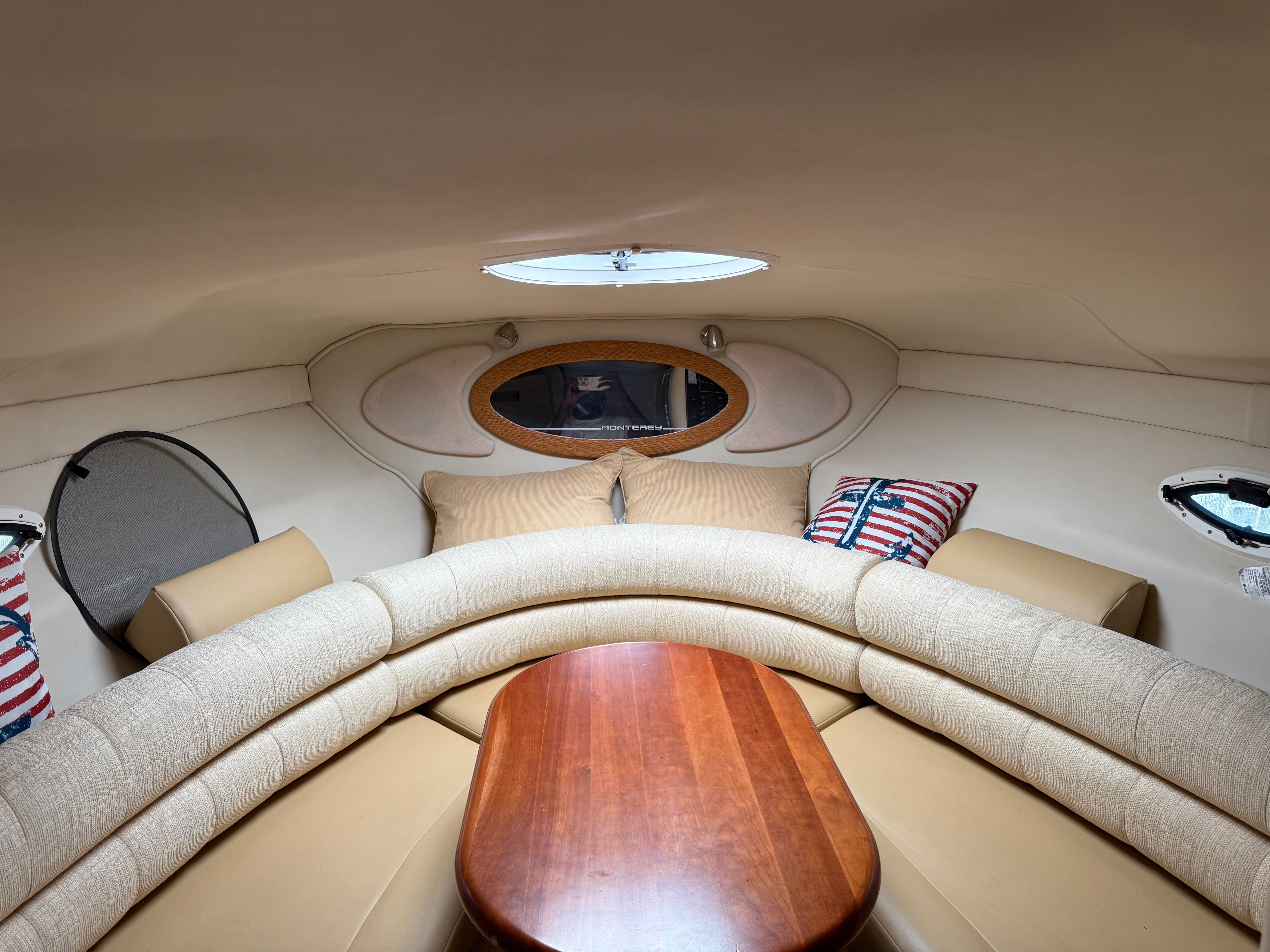 Interior of the 2006 Monterey 270 Cruiser with beige sofa and wooden table.