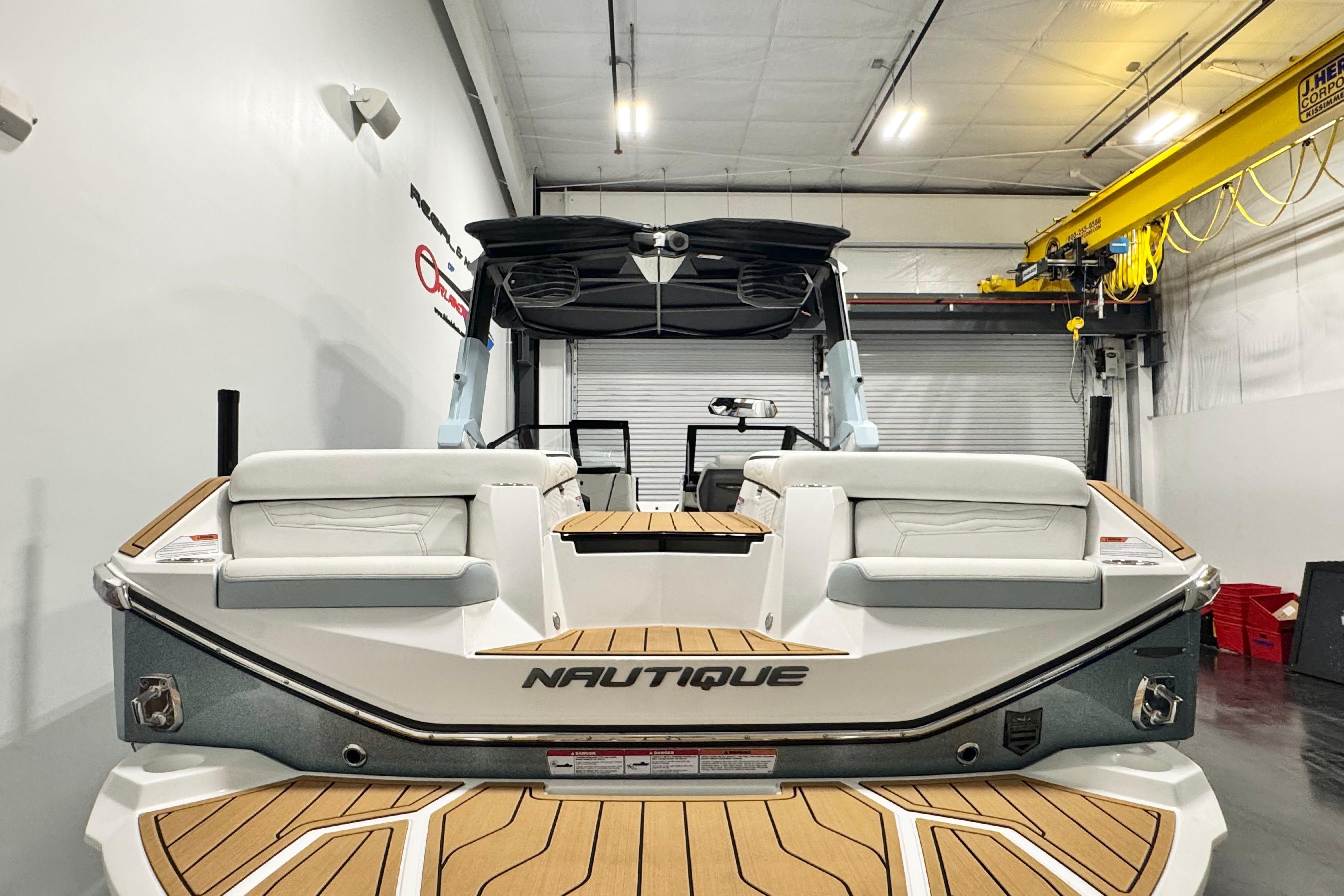 2026 Nautique Super Air Nautique G23 Paragon in a showroom, rear view.
