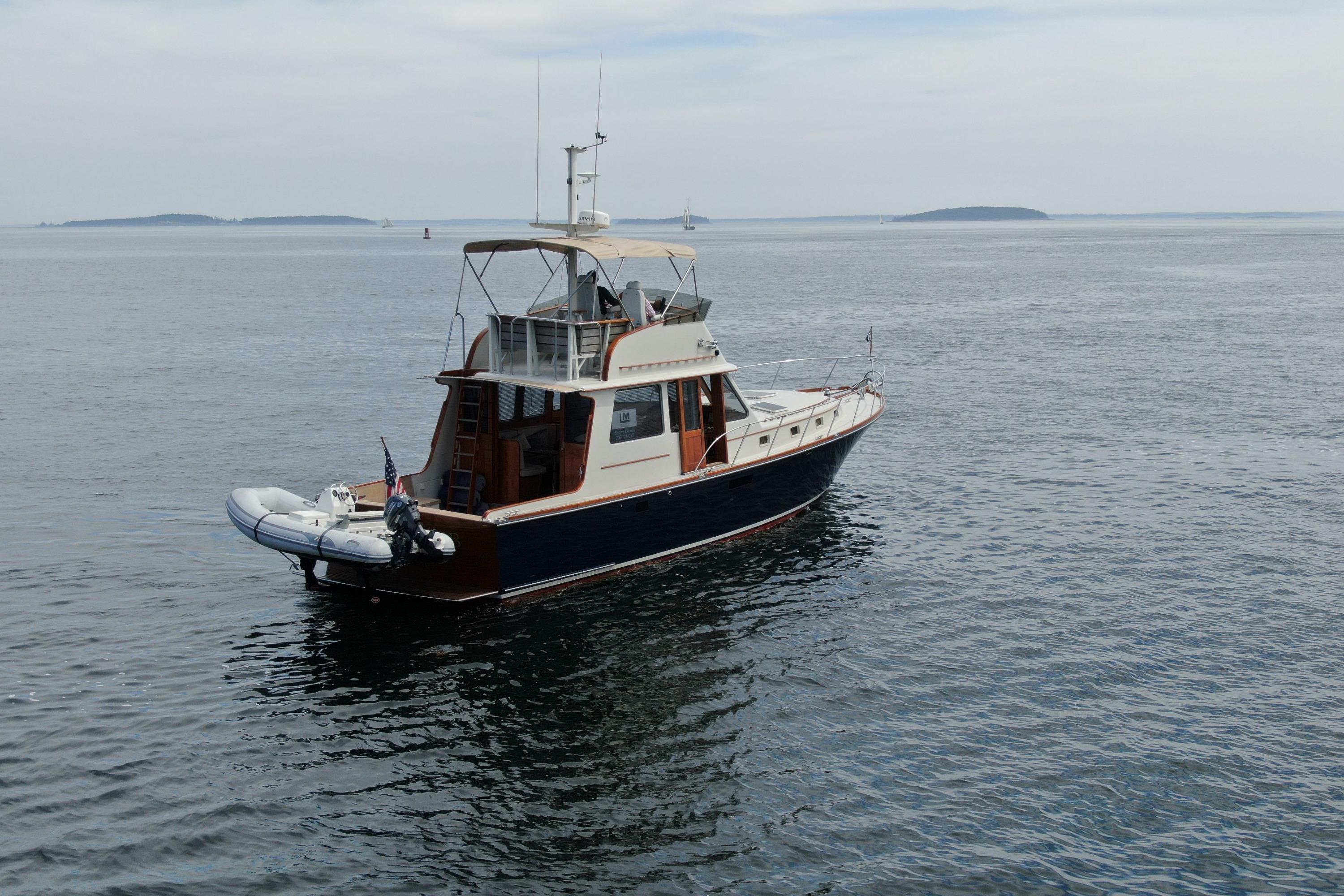 1997 Lyman-Morse Custom Flybridge yacht on calm ocean waters.