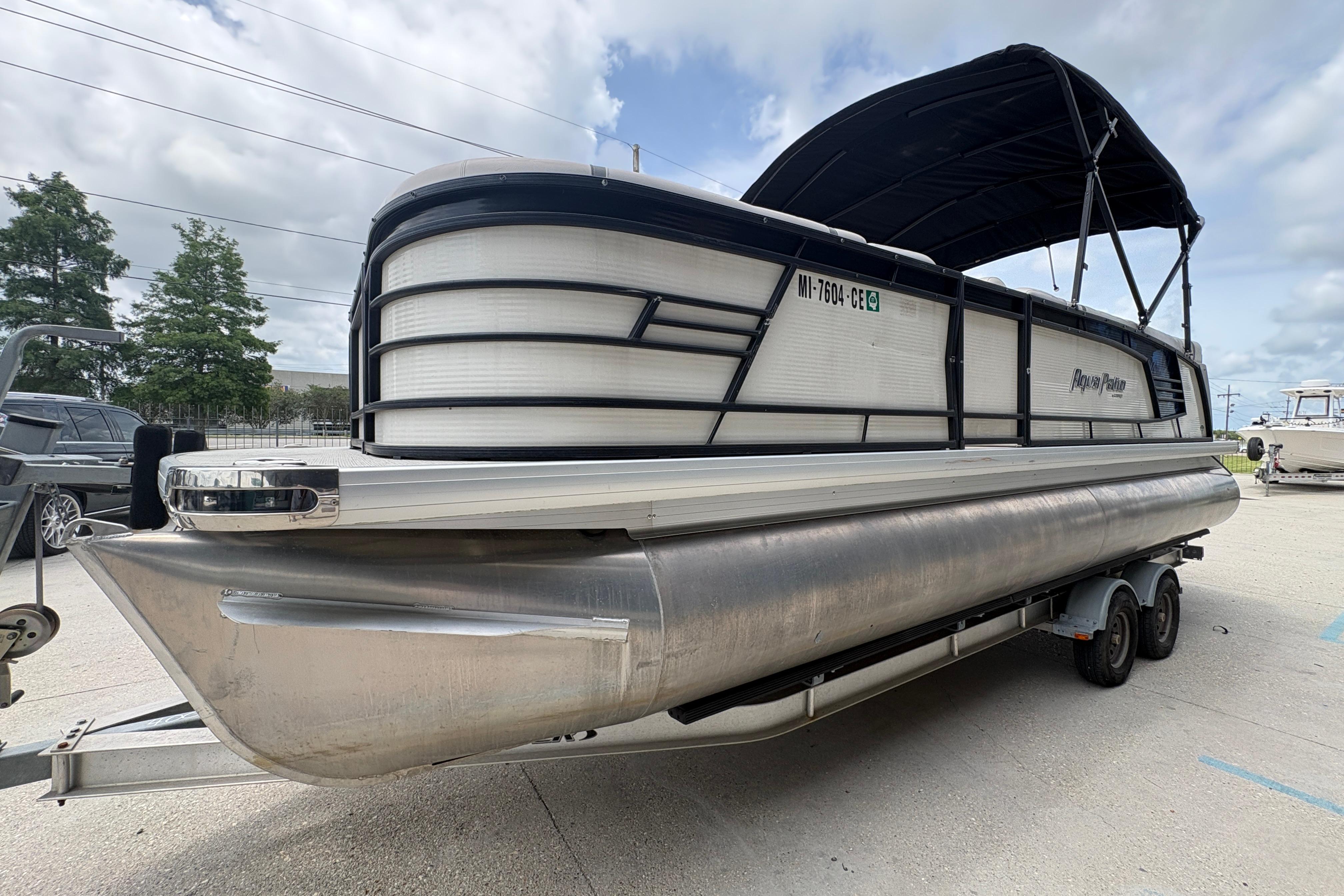 2019 Godfrey Aqua Patio pontoon boat on trailer under cloudy sky.