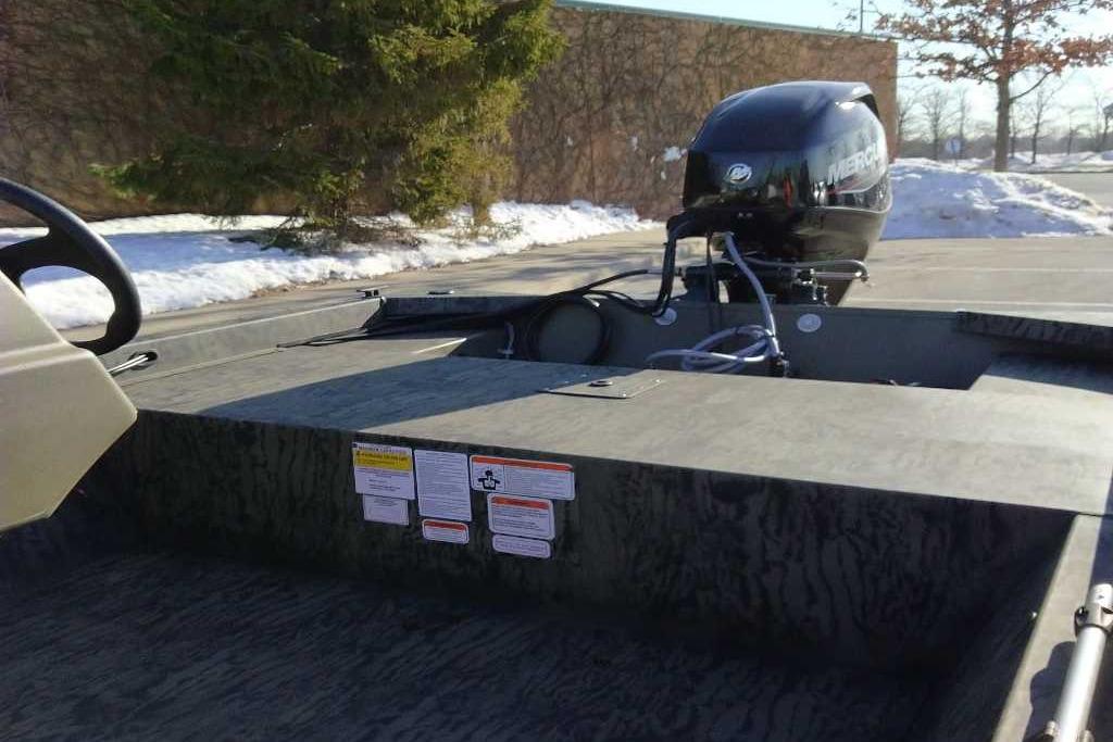 2026 Tracker Grizzly 1648 SC boat with Mercury outboard motor in snowy setting.