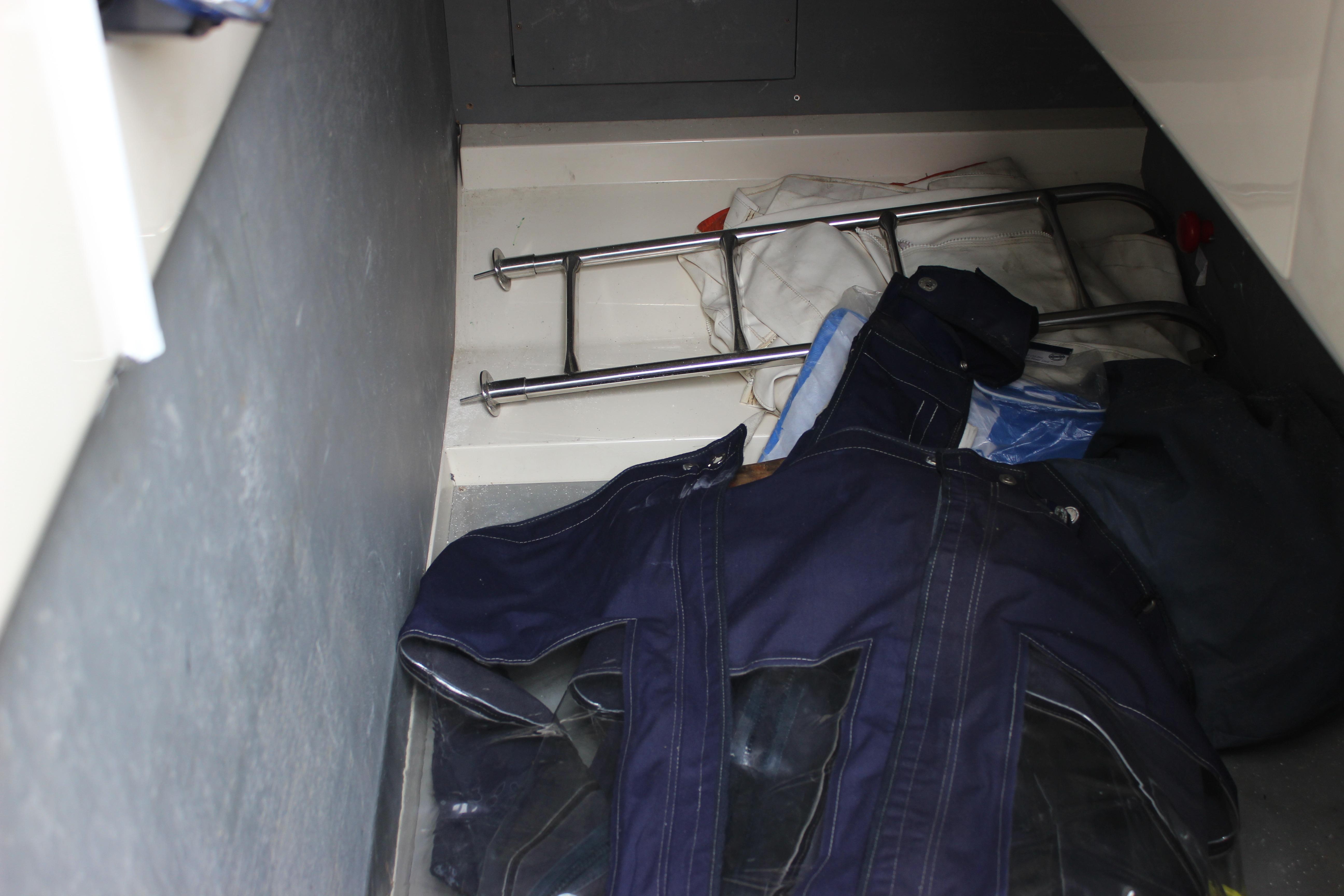 Storage compartment in a 2006 Fairline Phantom boat with miscellaneous items.