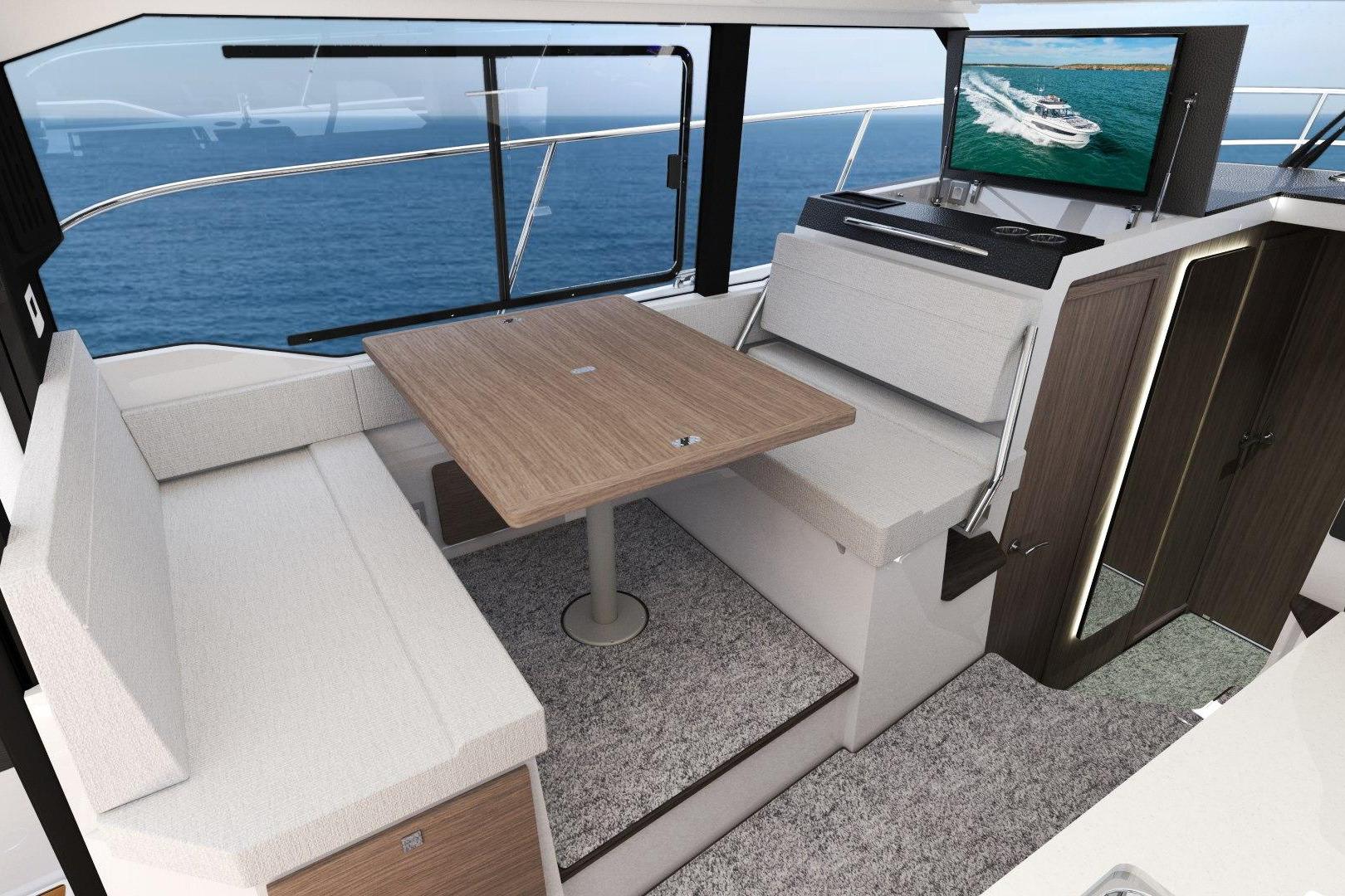 Manufacturer Provided Image: Interior of 2026 Jeanneau NC 1095 Coupe Series 2 with dining area and ocean view.