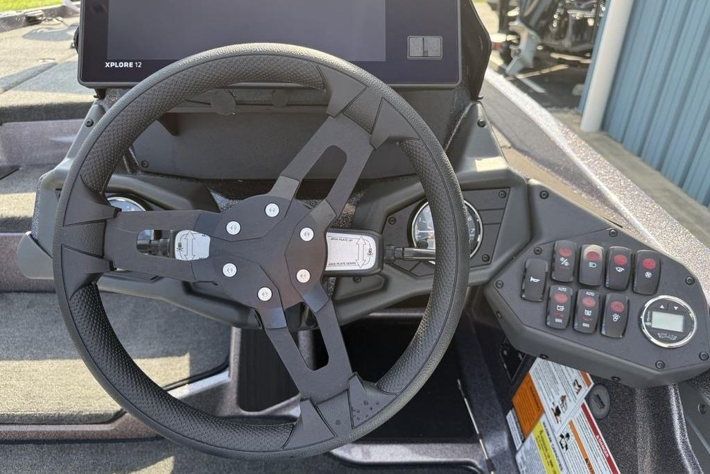 Steering wheel and dashboard of 2026 Skeeter ZXE20 boat with control panel and display.
