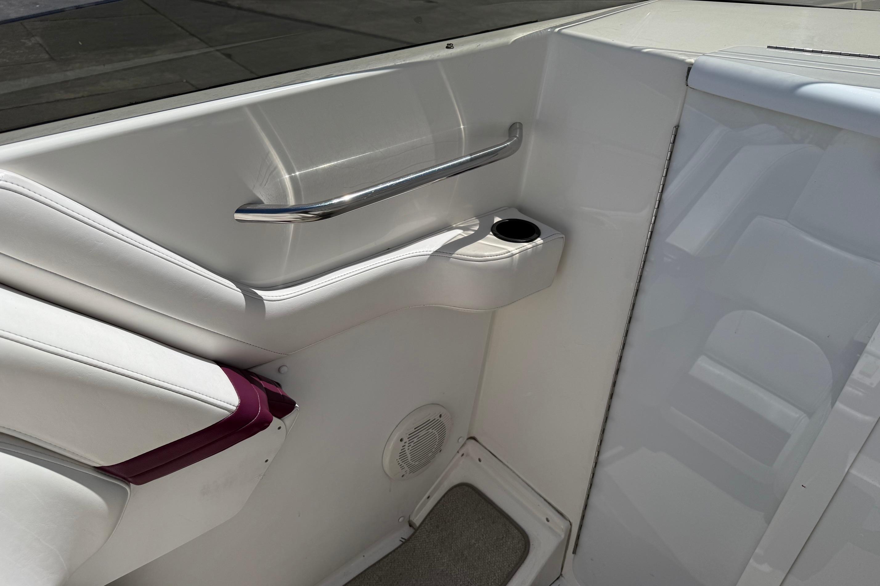 Interior of 1998 Fountain 35 Lightning boat with white seating and cup holder.