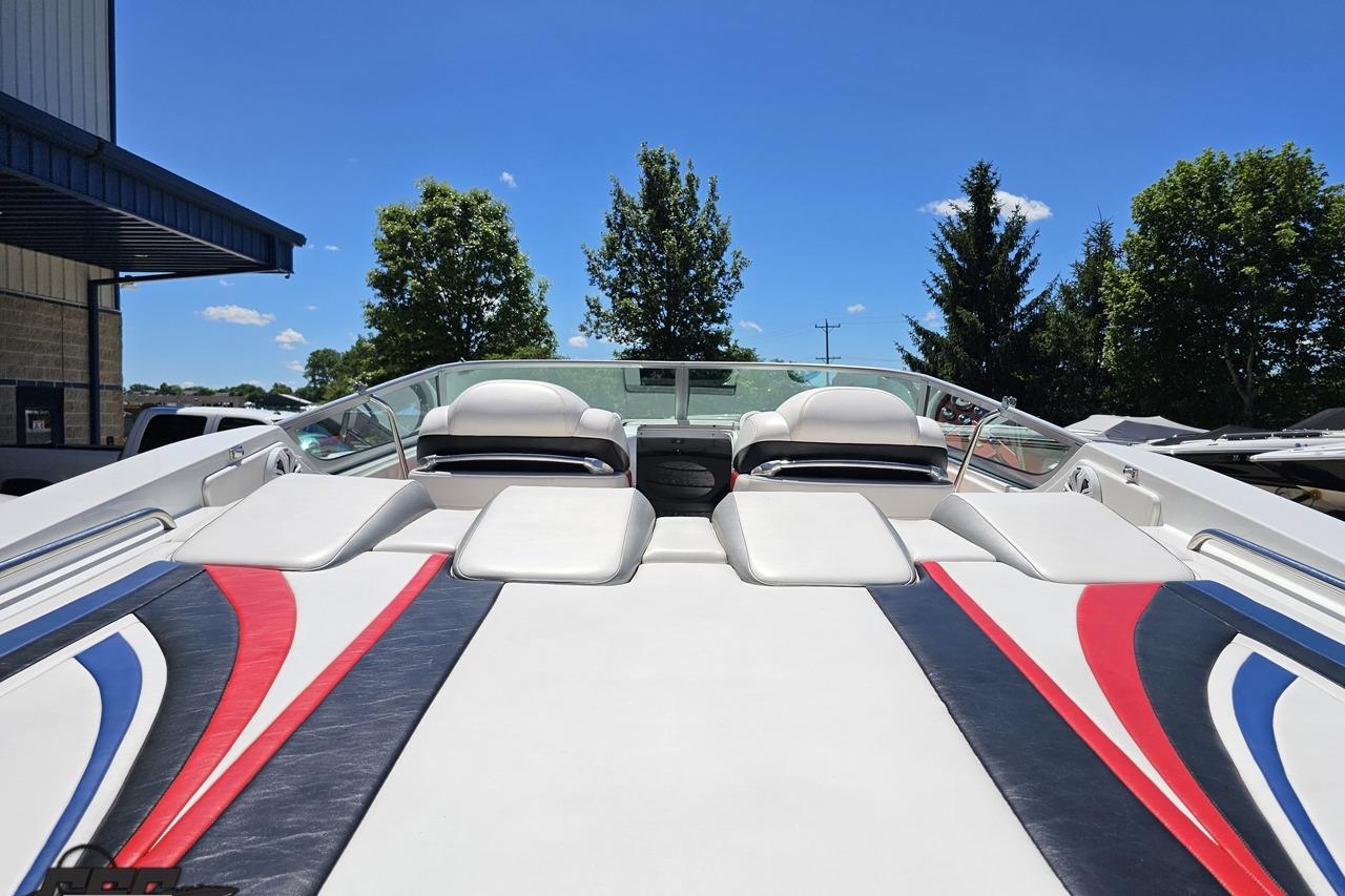 2005 Formula 271 FASTech boat interior with colorful upholstery under a clear blue sky.